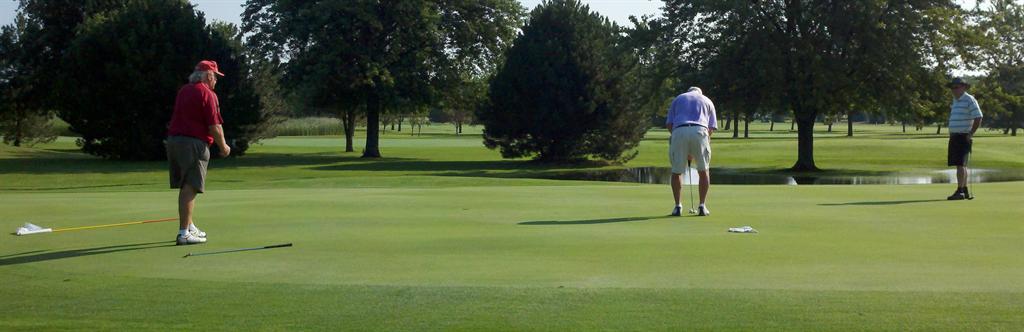 Gene Rhode lines up a putt on the final round of the senior tournament while Jack LeSage and Stan Harwood look on. 